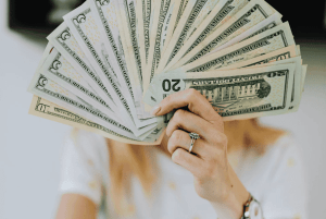 Person holding fan of cash