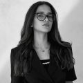 Woman in professional black outfit with glasses, Yucatan setting.